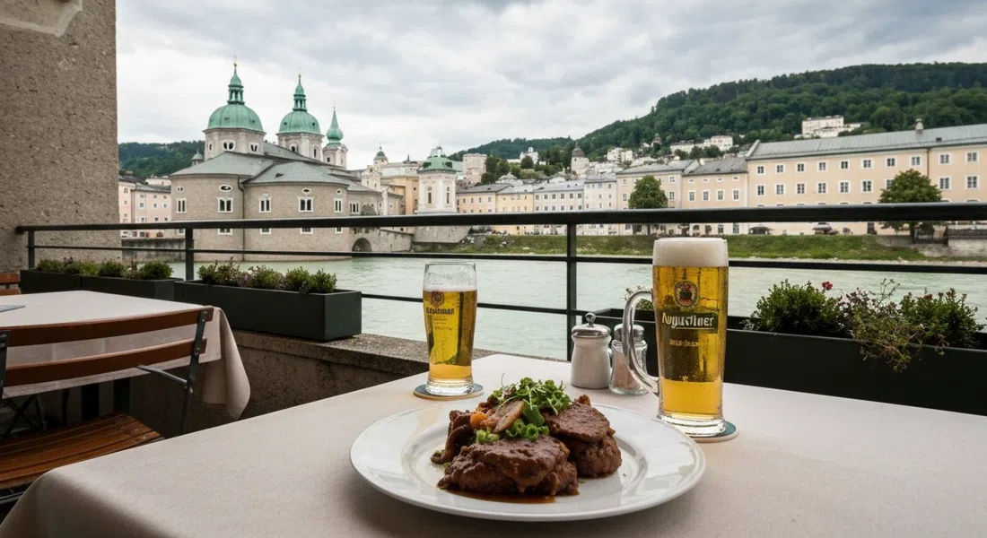 Bärenwirt位于莫尔恩主街8号的露台餐桌,摆盘讲究的Backhendl和一杯奥古斯丁啤酒,背景是萨尔察赫河和卡布齐纳山